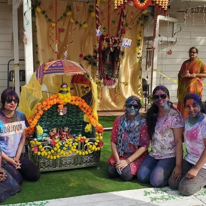 Three devotees posing at ISKCON Cedar Park event
