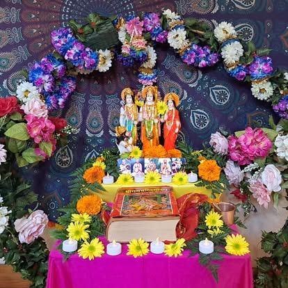 Colorful flower altar with religious deity statues at ISKCON Cedar Park
