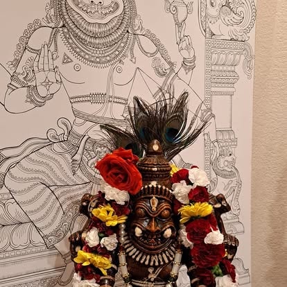 Hindu deity statue adorned with flowers at ISKCON Cedar Park
