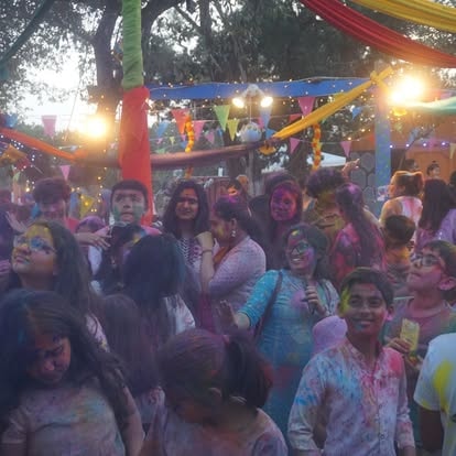 Crowd celebrating Holi festival with colors at ISKCON Cedar Park