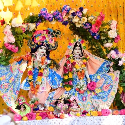 Hindu deity statues decorated with colorful flowers at ISKCON Cedar Park