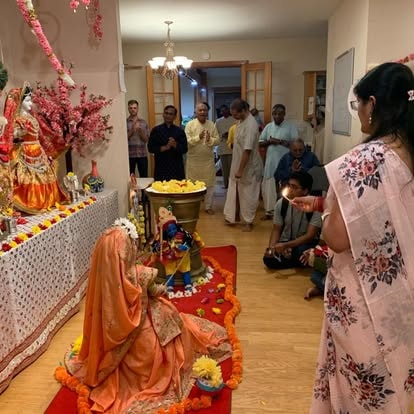 Family celebrating Diwali with religious altar decorations at ISKCON Cedar Park