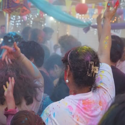 Colorful Holi festival celebration with crowd at ISKCON Cedar Park