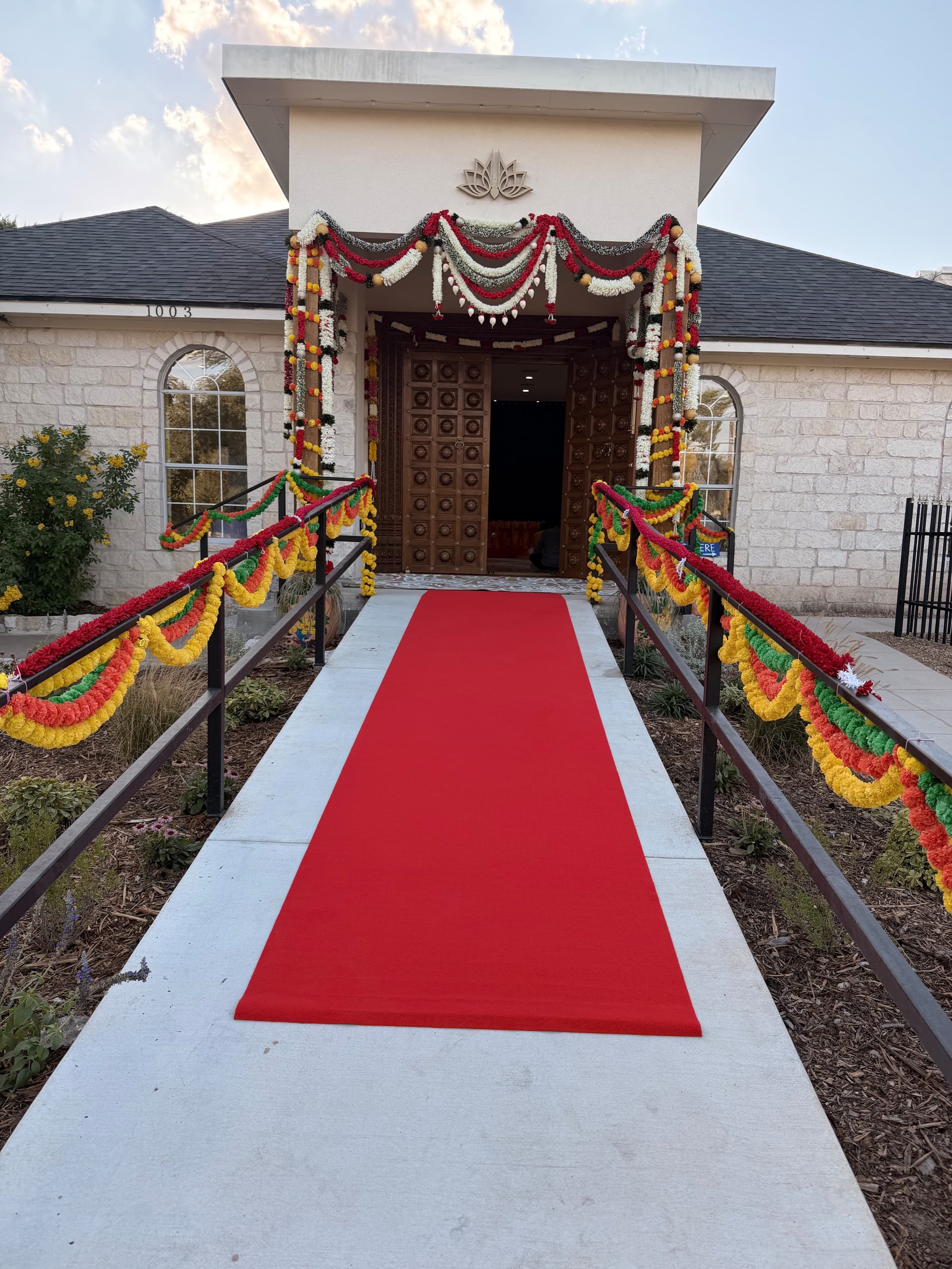 Hare Krishna Temple of Austin entrance decorated with flower garlands and a red carpet